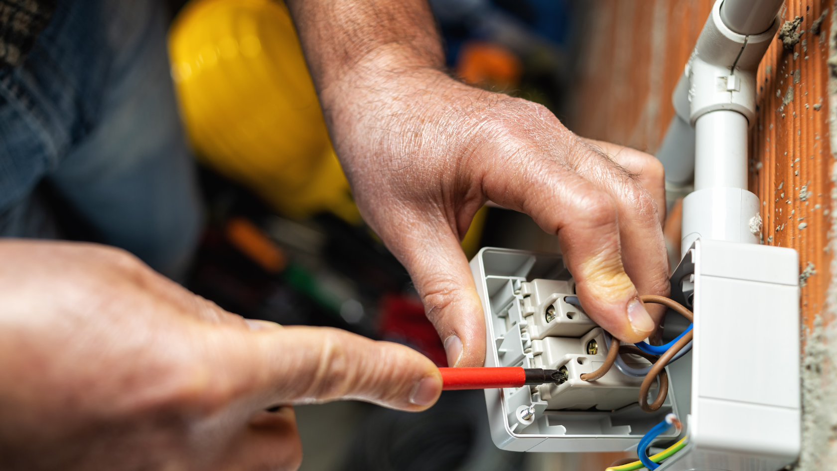 A close up of a person working on an electrical device